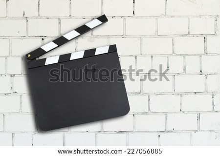 Blank movie production clapper board against a brick wall