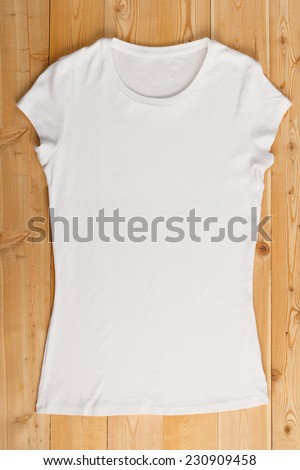 Blank white t-shirt on a wooden background