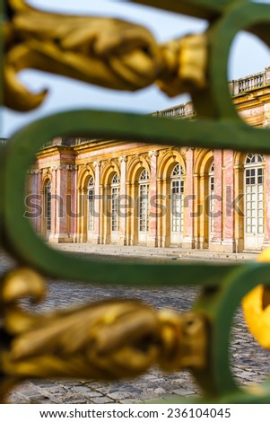 View at Grand Trianon Versailles through the fence. Focus on the palace