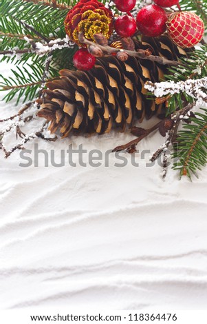 Christmas composition with pine cone on the snow.