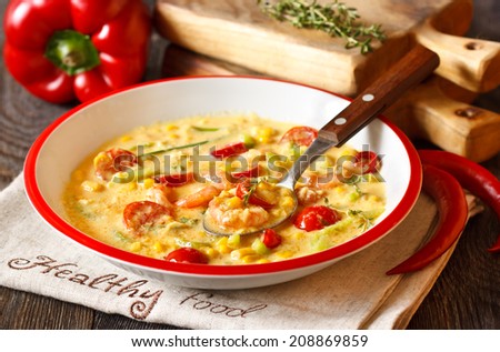 Cheddar corn shrimp chowder with chili and thyme close-up.