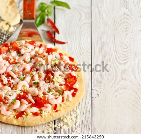 Hot shrimp pizza on a pizza maker shovel with copy space for recipe.