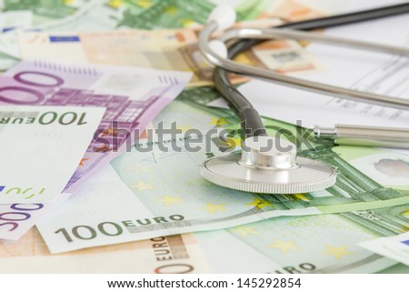 Euro with stethoscope on them. Costs for the medical insurance.