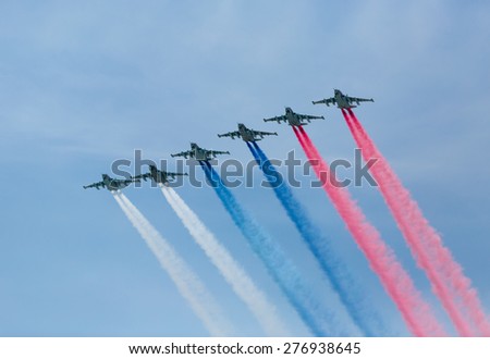 Moscow, Russia - May 9, 2015: A group of aircraft in-flight smoke color Russian flag at Parade of Victory in World War II on May 9, 2015 in Moscow.