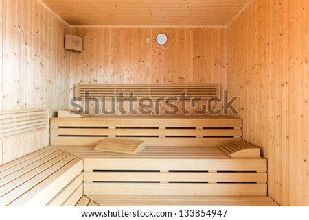 healthy wooden steam sauna with clock and wood loungers