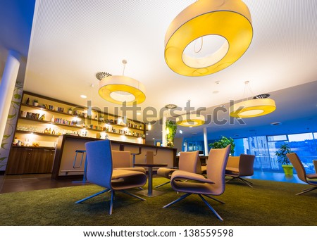 wide angel of modern lounge in hotel bar with huge lamps