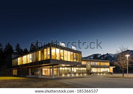 illuminated modern wooden office building at night