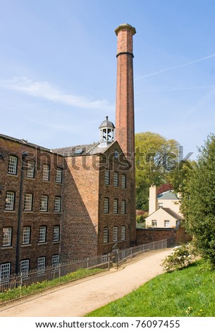 Cotton mill dating from the industrial revolution against a blue sky