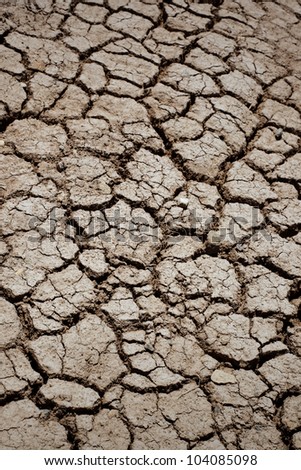Drought season, dried cracked earth under the blazing sun