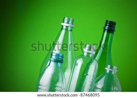 Recycling plastic bottles, green background, shallow depth of field, copy space