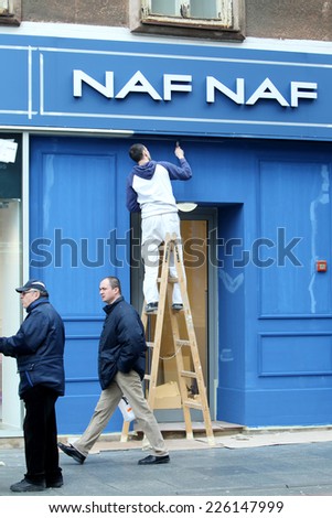 ZAGREB, CROATIA - FEBRUARY 24 : Worker wall painting the exterior of a NAF NAF store on February 24th, 2014  in Zagreb, Croatia. NAF NAF is a French brand of women\'s clothing and accessories.