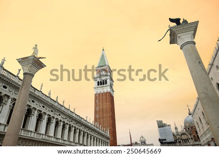 A view of San Marco bell tower and the columns of San Marco and San Todaro in Venice, Italy. Columns of San Marco and San Todaro are the monumental entrance to the city for those coming from the sea.