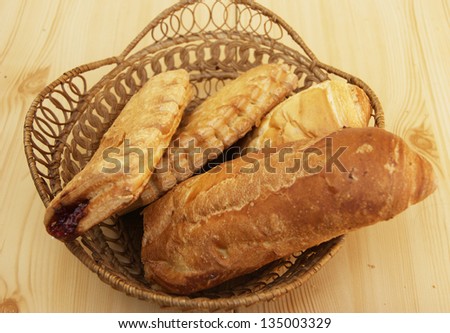 Long loaf of bread and home baking in basket