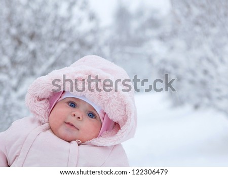 little girl walks in the winter when it snows