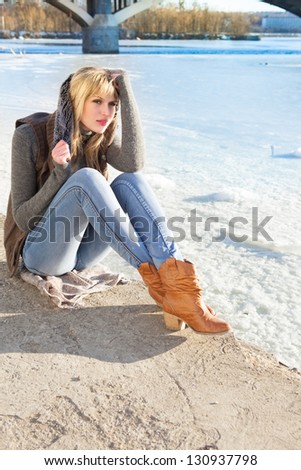 sensual blonde is next to the river on a sunny day