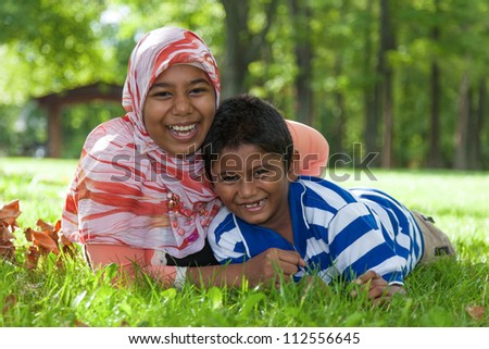 Outdoor portrait of indian brother and sister