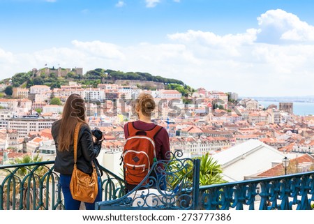 Tourist watching to Lisbon rooftop from Sao Pedro de Alcantara viewpoint - Miradouro in Portugal