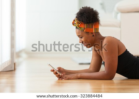 Similar – Image, Stock Photo Black woman sending a message on smartphone near sea in sunset