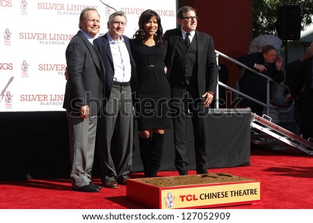 LOS ANGELES, CA - FEB 4: Billy Crystal, Robert De Niro, Grace Hightower, David O Russell as Robert De Niro gets with hand + foot prints at TCL Chinese Theater on February 4, 2013 in Los Angeles, CA