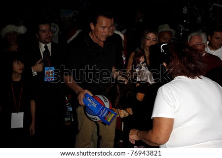 LOS ANGELES - DEC 19: Arnold Schwarzenegger passes out toys at the  Hollenbeck Youth Center\'s 28th \