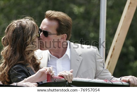 LOS ANGELES - APRIL 2: Maria Shriver kisses husband governor Arnold Schwarzenegger at the softball game before the 'The Benchwarmers' movie premiere at UCLA in Los Angeles, CA on April 2, 2006