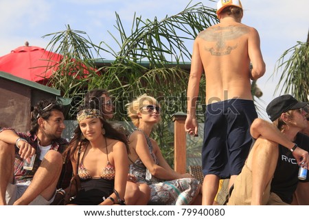 MALIBU, CA - AUG 26: Paris Hilton talks to Kid Rock (tattoo) at a party at the LG House on the beach in Malibu, California on August 26, 2007