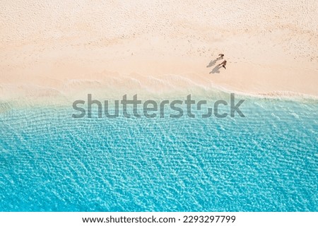 Similar – Image, Stock Photo Romantic couple walking on foamy sea waves