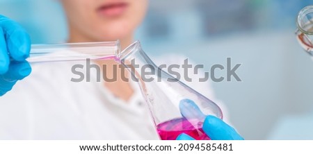 Similar – Image, Stock Photo Young scientist pipetting solution.