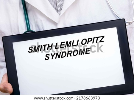 Smith Lemli Opitz Syndrome.  Doctor with rare or orphan disease text on tablet screen Smith Lemli Opitz Syndrome ストックフォト © 
