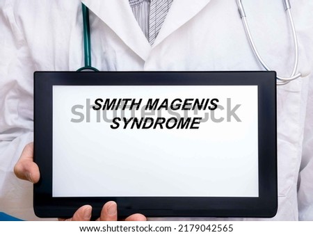 Smith Magenis Syndrome.  Doctor with rare or orphan disease text on tablet screen Smith Magenis Syndrome ストックフォト © 