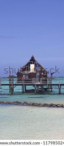 workers repairing an over water bungalow