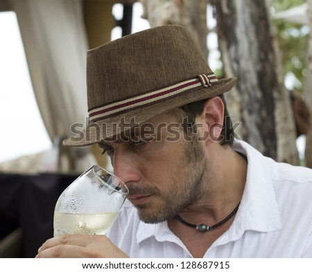 image of a man smelling white wine