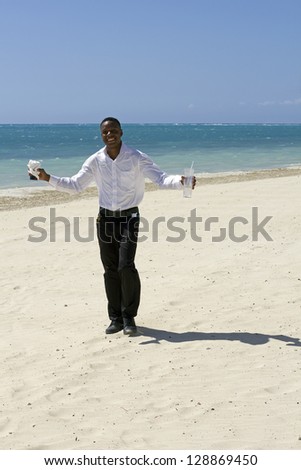 beautiful young jamaican waiter smiling on the beach