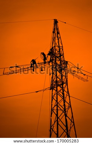 man at work on high voltage pylon
