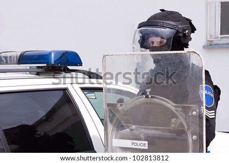 police officer in a protective helmet and visor, preparation for the demonstration