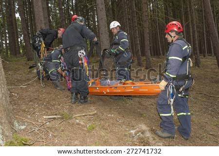 Pnovany, Czech Republic, June 4, 2014: Training rescue of injured people in difficult terrain at the dam Hracholusky, carrying a stretcher with an injured person