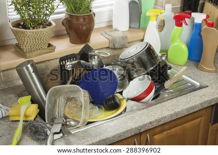 Dirty dishes in the sink after family celebrations. Home cleaning the kitchen.