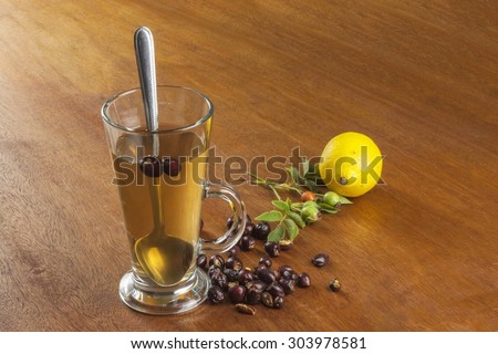 Hot tea with lemon and red arrow in the table. Home treatment for colds and flu. Treating colds using traditional recipes.