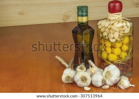 Garlic, aromatic ingredients for flavoring food. Home remedy for colds and flu. Garlic marinated in olive oil. Seasoning food. Preparing for the garden party and barbecue meat