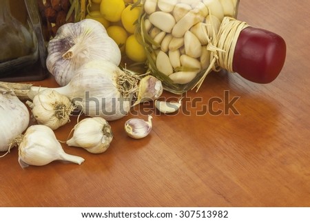 Garlic, aromatic ingredients for flavoring food. Home remedy for colds and flu. Garlic marinated in olive oil. Seasoning food. Preparing for the garden party and barbecue meat
