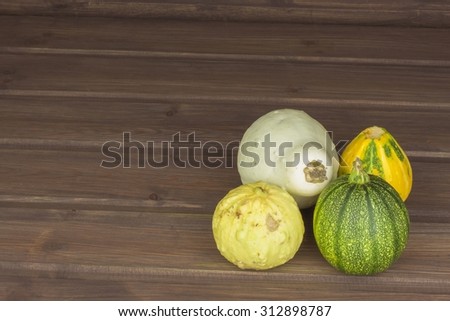 Autumn harvest of pumpkins. Preparing for Halloween. Growing vegetables in a home garden. Place for your text. Autumn pumpkins with leaves on wooden board