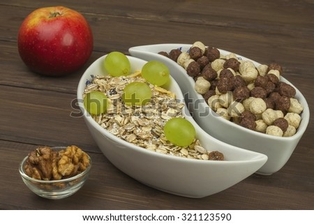 Healthy Diet breakfast of oatmeal, cereal and fruit. Foods full of energy for athletes. The concept of diet food. Preparing homemade breakfast. Vegetarian diet. Food on a wooden table.