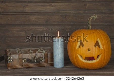Halloween pumpkin head on wooden background. Preparing for Halloween. Head carved from a pumpkin on Halloween. Scary Halloween pumpkin. Mysterious locked cabinet. Pandora\'s box.