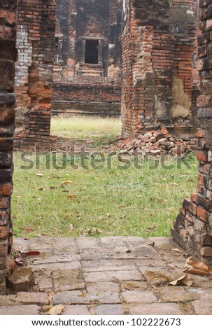 Ruins of window Buddhist church, which is looking through an old brick wall.