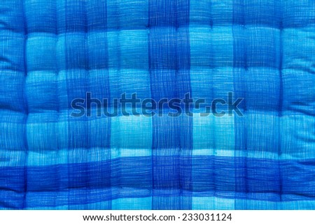 Close up background beautiful blue and white corrugated bed quilt.