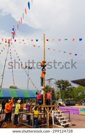 Climb Racing bamboo poles.\
PHIcHIT THAILAND-APRIL 9:\
Male Thailand are helping each other climb a bamboo pole to pick up objects on the festival.On April 20, 2014 in Phichit, \
Thailand.