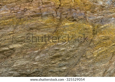 Close up background texture of cutting layers of weathered granite cliff erosion is a long time.