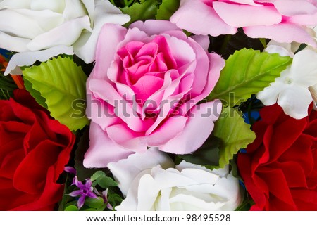 Artificial pink roses. Details of artificial roses, pink, red and white.