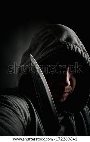 Street robber holding a knife