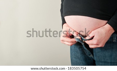 Pregnant woman struggling to get dressed